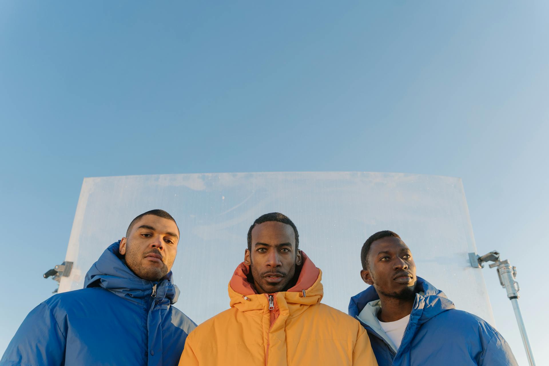 cross section of 3 men in puffer jackets
